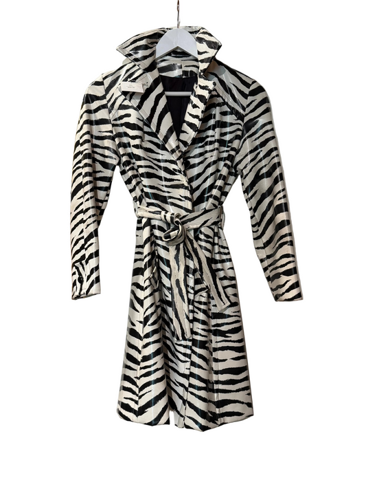 VINTAGE Zebra-patterned coat hanging on a white door 